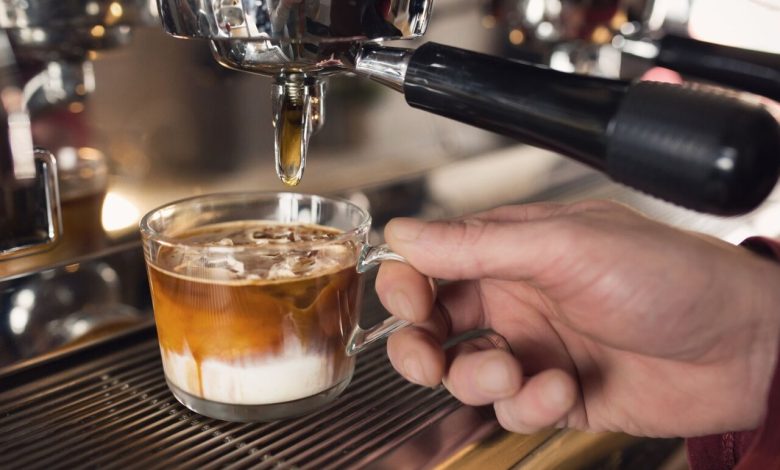A person pouring a coffee into a cup